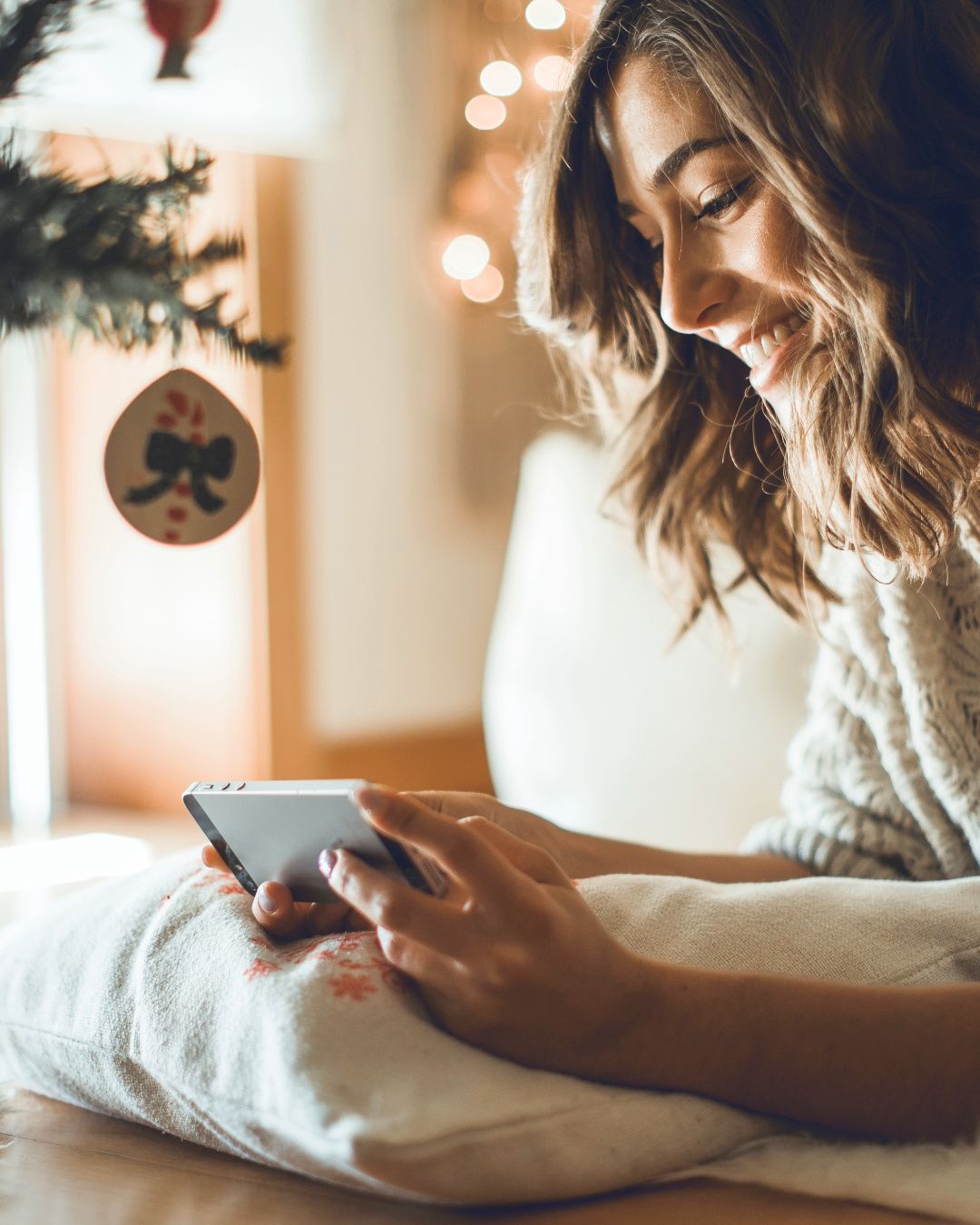 holiday theme, girl looking at phone smiling